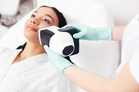 Selective focus of the skin analysis camera in hand of beautician Stock Photos
