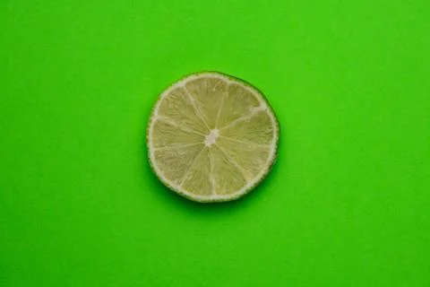 Selective focus, a slice of lime on a plain background Stock Photos
