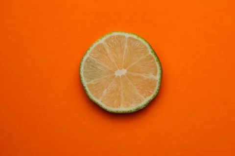 Selective focus, a slice of lime on a plain background Foto stock
