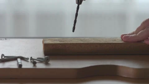 Selective focus slow motion footage of drilling a wooden board 스톡 동영상 264156942