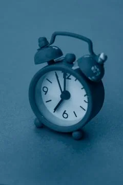 Selective focus, small blue alarm clock with numbers Stock Photos