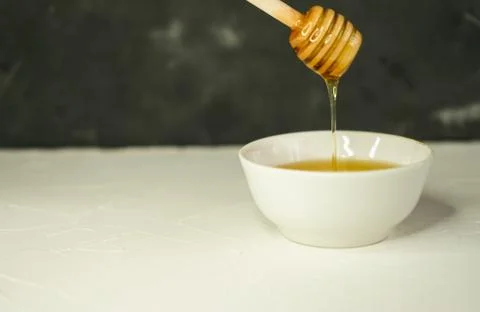 Selective focus, small Cup with natural honey and spoon Stock Photos