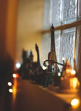 A selective focus of a small Eiffel Tower souvenir on the windowsill decorate Stock Photos