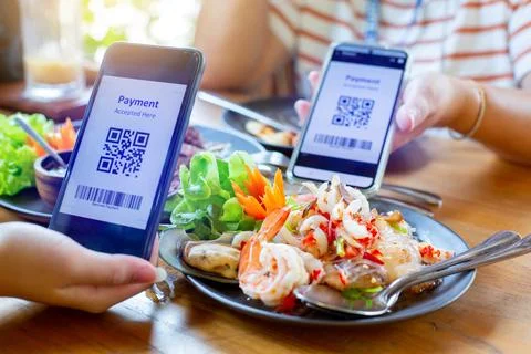 Selective focus to smartphone in hand to scan QR code on tag with blurry sp.. Stock Photos