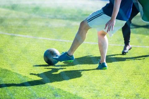 Selective focus to soccer player control and shoot ball to goal with goalkeep Stock Photos