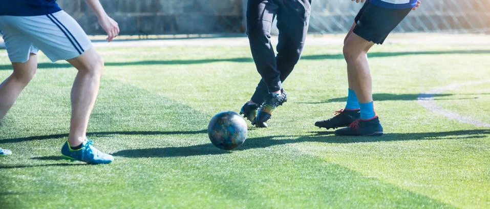 Selective focus to soccer player control and shoot ball to goal with goalkeep Фото