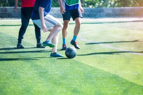 Selective focus to soccer player control and shoot ball to goal with goalkeep Stock Photos