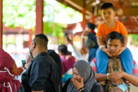 Selective focus, soft focus. A crowd of visitors to the zoo in Malaysia, watc Stock Photos