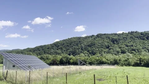 Selective focus on solar panels in lush mountain landscape Stock Footage 313713590