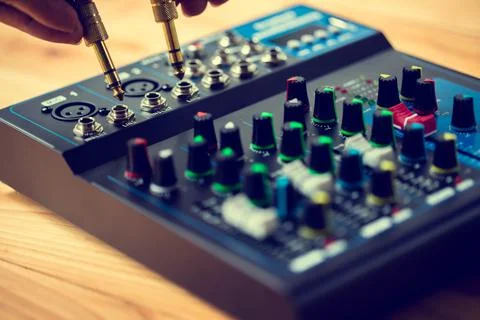 Selective focus to sound electronics mixer and gold mic jack. Stock-Fotos