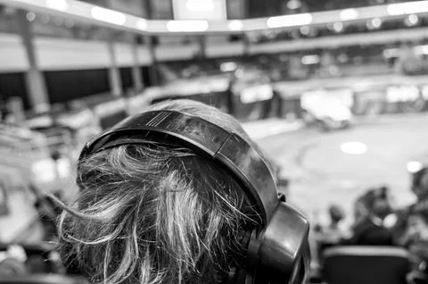 Selective focus on spectators in the stands with hearing protection watching a Stock Photos