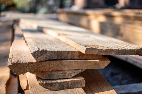 Selective focus on staked rough cut lumber at a saw mill Stock Photos