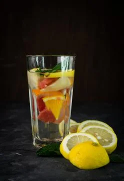 Selective focus, a tall glass of water and citrus fruits Stock Photos