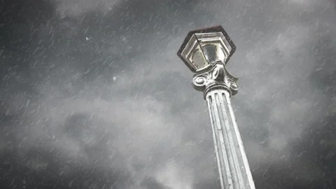 Selective focus on a tall lamp post during a snow storm with dramatic clouds Vídeo Stock 130037142