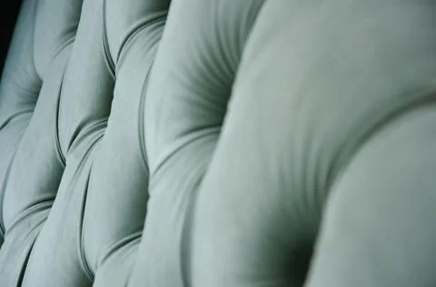 Selective focus texture of velour sofa with buttons. Concept of comfort. Stock Photos