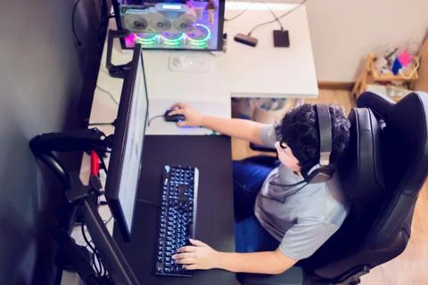 Selective focus to top view of Asian gamer playing games on computer in the r Stock-Fotos
