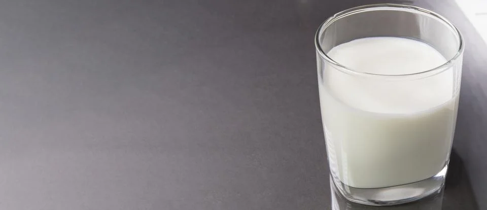 Selective focus top view of a clear glass of milk against the background of a Stock Photos