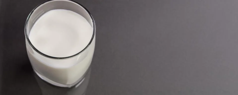 Selective focus top view of a clear glass of milk against the background of a Stock Photos