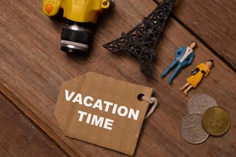 Selective focus of toy camera, Eiffel Tower toy, people miniatures and coins Stock Photos