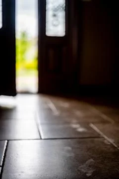 Selective focus on Track of small child footprints visible on a tile floor with Stock Photos