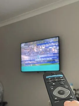 Selective focus on tv remote control in the hand Stock Photos