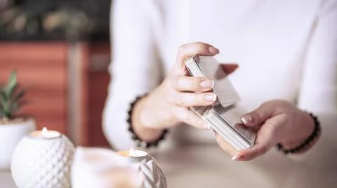 Selective Focus of two hands shuffling and adjusting tarot cards Stock Photos