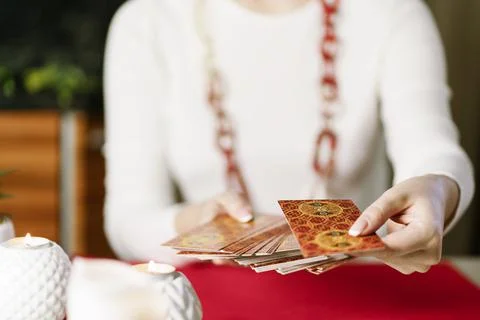 Selective Focus of two hands shuffling and adjusting tarot cards Stock Photos