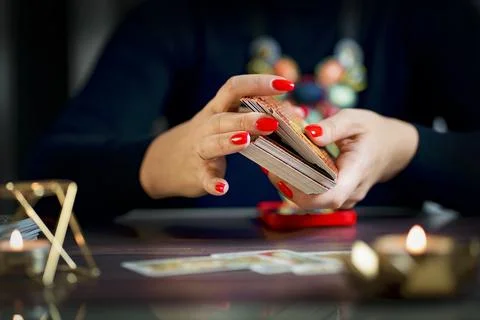Selective Focus of two hands shuffling and adjusting tarot cards Stock Photos
