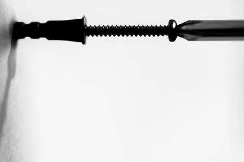 Selective focus on a typical drywall anchor installation . Stock Photos