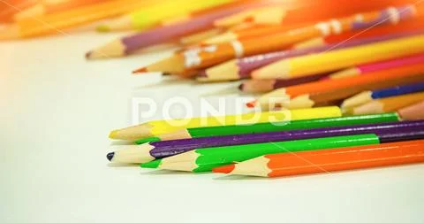 In selective focus of used color pencil put on desk,warm light tone,blurry li Stock Photos