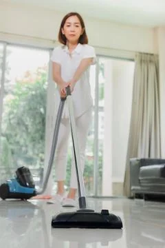 Selective focus at vacuum cleaner. Clean on the living room, apartment or hom Stock Photos