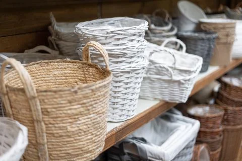Selective focus of various wicker flower pots and baskets on a shelf in a Stock Photos