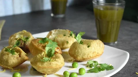 A Selective focus Video of an Indian Snack called Pani Puri on a table with Peas Stock Footage 167382375