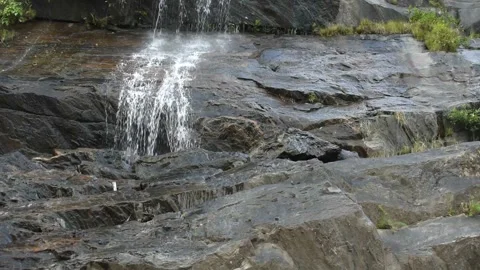 Selective focus Video of a small waterfall on the rocky cliff in India Stock Footage 167382574