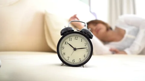 Selective focus at vintage alarm clock and sleeping Asian woman Stock Footage 86804479