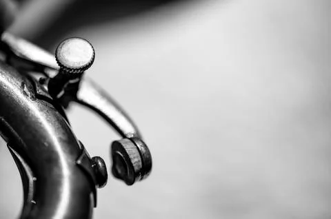 Selective focus on a water key of an aged wind instrument trumpet. Stock Photos