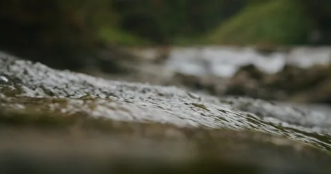 Selective focus on water surface with blurred river flow in the background Stock Footage 265004154