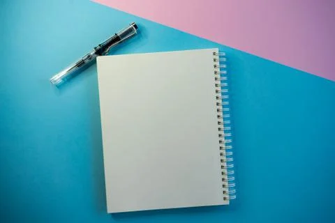 Selective focus, white blank Notepad under copyspace, on colored background Stock Photos