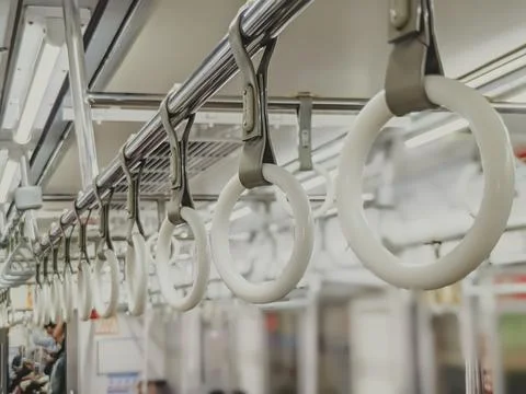 Selective focus. White circular formed passengers handrails in the train Stock Photos