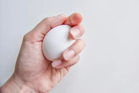 Selective focus at the white egg in the hand Stock Photos