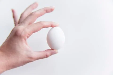 Selective focus at the white egg in the hand Stock Photos