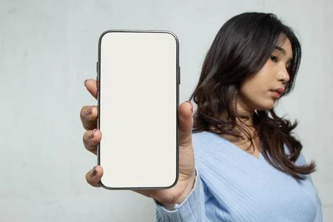 Selective focus white screen mobile phone with blurred long hair woman Stock Photos