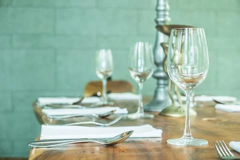 Selective focus on Wine glass on table dinner in restaurant - filter effect Stock Photos