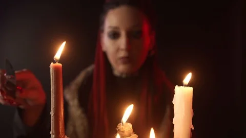 Selective focus of witch with candles and knife Video stock 126098249