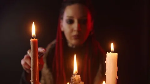 Selective focus of witch with knife and candles Stock Footage 123962558