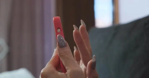 Selective focus. Womens hands scroll through the Internet pages on the phone Stock Footage 166936706