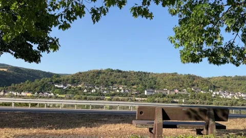 Selective focus wooden bench overlooking the scenic Rhine Valley Stock Footage 345592609