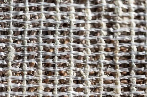 Selective focus on woven polypropylene layer backing of carpet used to provide Stock Photos