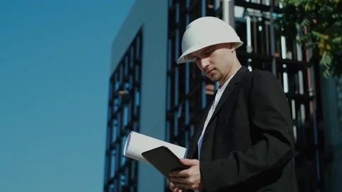 Selective focus of young caucasian civil engineer wearing safety helmet and vest Stock Footage 249263053