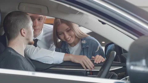 Selective focus on a young person choosing a new car while communicating with Stock Footage 147189626